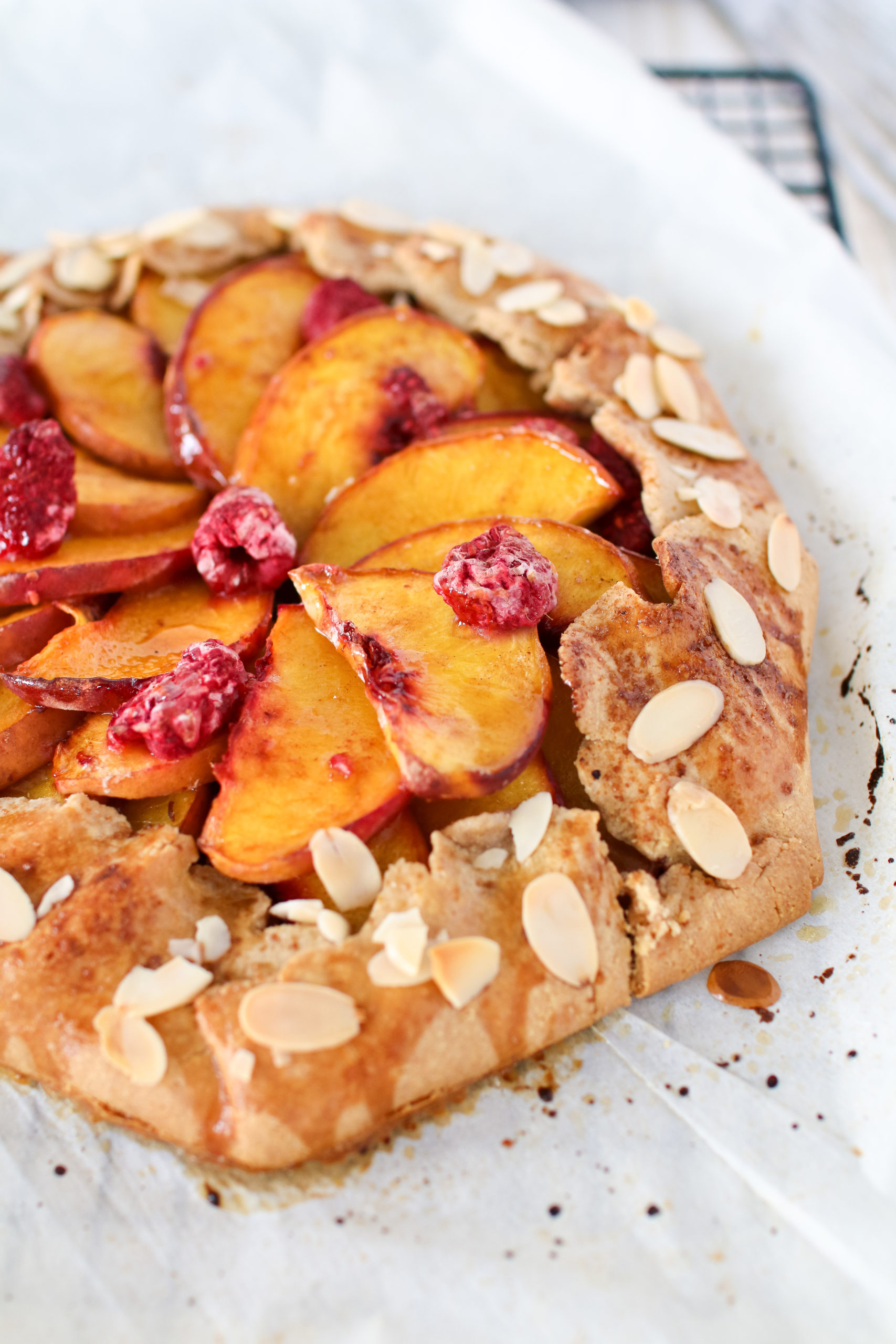 A rustic Peach Raspberry Galette filled with juicy peaches and tart raspberries, for the perfect end of summer dessert & the easiest pie you will ever make!