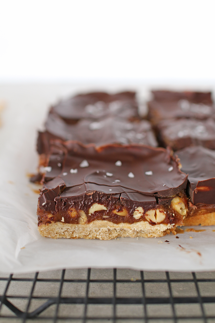 Decadent homemade Snickers Shortbread Cookie Bars made with a buttery shortbread base, sweet caramel nutty middle, topped with chocolate, that will melt in your mouth with every bite.