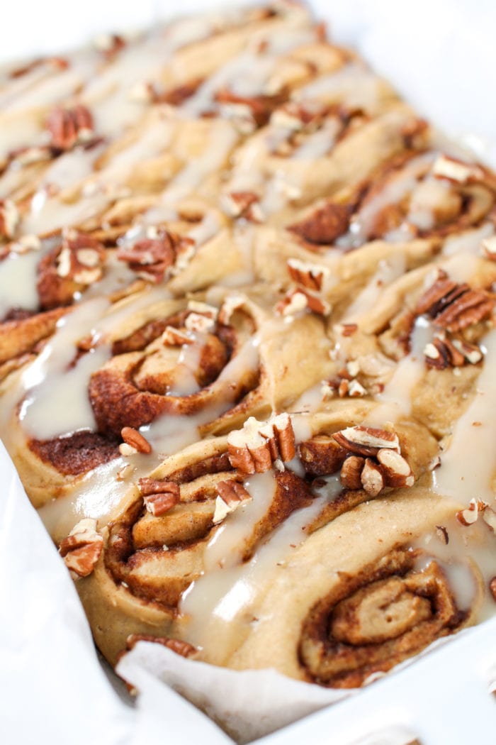 These warm, gooey, soft, homemade cinnamon rolls drizzled in the most delicious refined sugar-free glaze are the perfect treat for breakfast and dessert this holiday season!