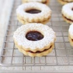 Healthier holiday linzer cookies filled with perfectly tart raspberry jam and covered in a dusting of powdered sugar for a beautiful and delicious treat!