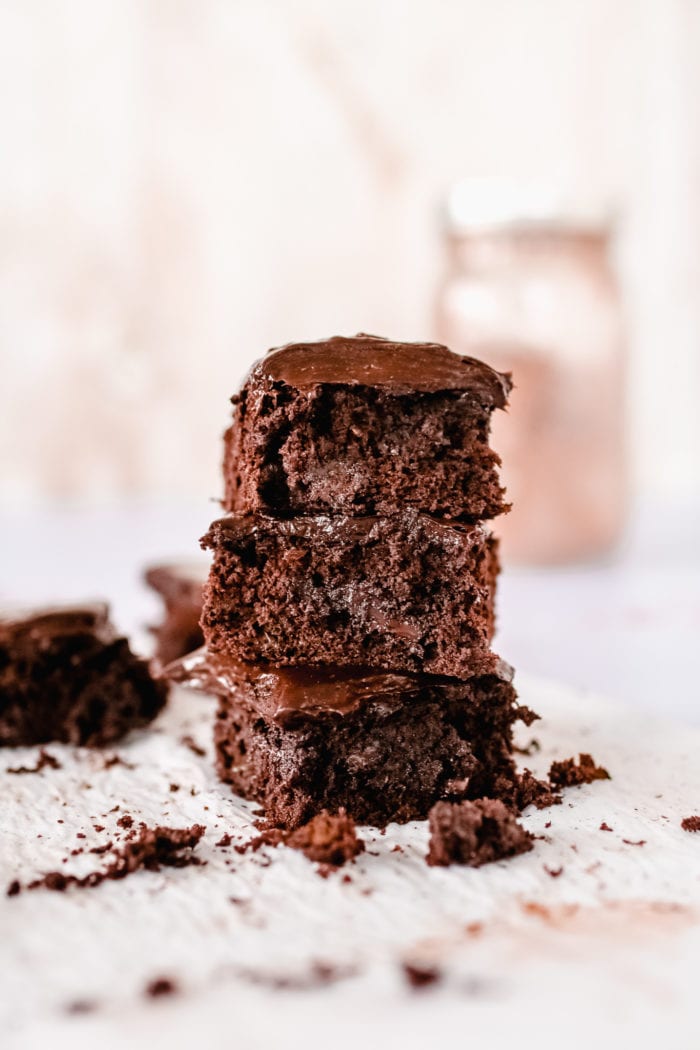 This gluten-free triple chocolate zucchini brownie slathered in chocolate avocado frosting is the ultimate decadent dessert but with a healthy twist.