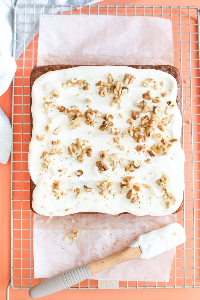 A healthier carrot cake, naturally sweetened with applesauce and maple syrup, loaded with freshly grated carrots, warming spices, topped with a honey cream cheese frosting and crunchy walnuts.