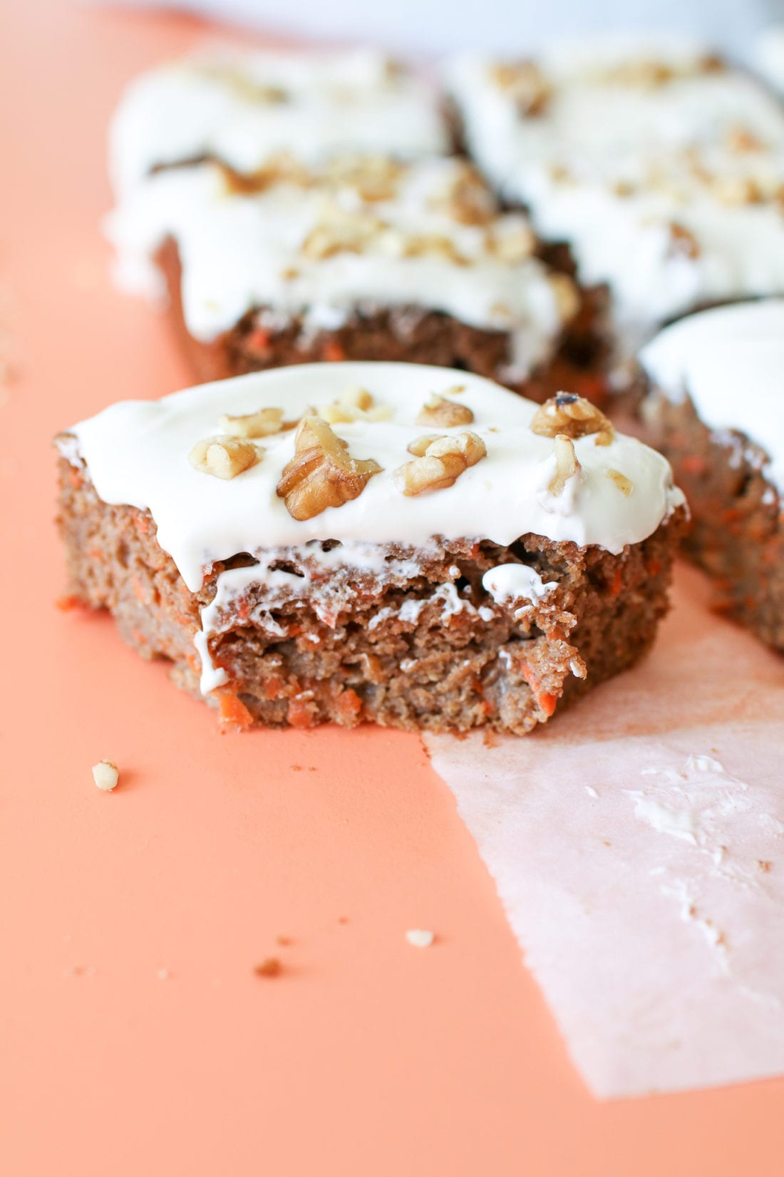 A healthy carrot cake, naturally sweetened with applesauce and maple syrup, loaded with freshly grated carrots, warming spices, topped with a honey cream cheese frosting and crunchy walnuts.