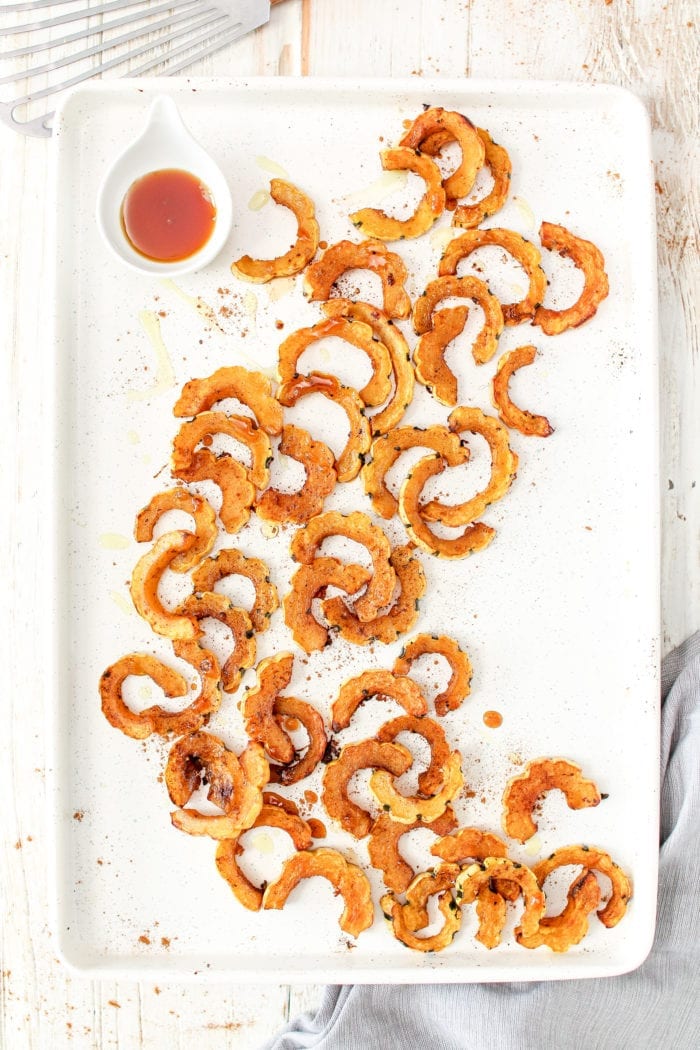 Buttery roasted delicata squash glazed with maple syrup and warming cinnamon for spice to create the perfect festive fall side to your dinner table. 