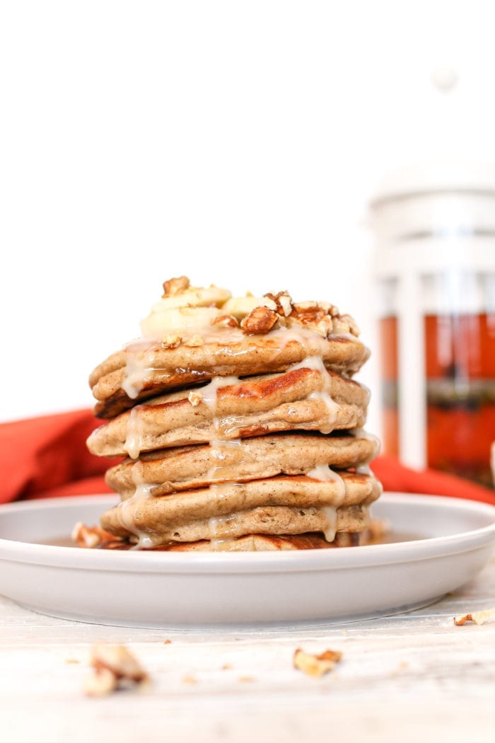 These simple and delicious, fluffy pancakes infused with warming chai spices and drizzled with a maple coconut butter glaze makes for a perfect cozy breakfast on a Sunday morning.