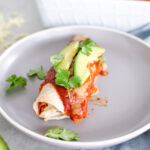 These Mexican inspired Chicken Black Bean Enchiladas are saucy, cheesy and a fun twist on taco Tuesday that will feed your entire family!