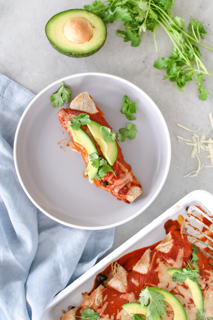 These Mexican inspired Chicken Black Bean Enchiladas are saucy, cheesy and a fun twist on taco Tuesday that will feed your entire family!