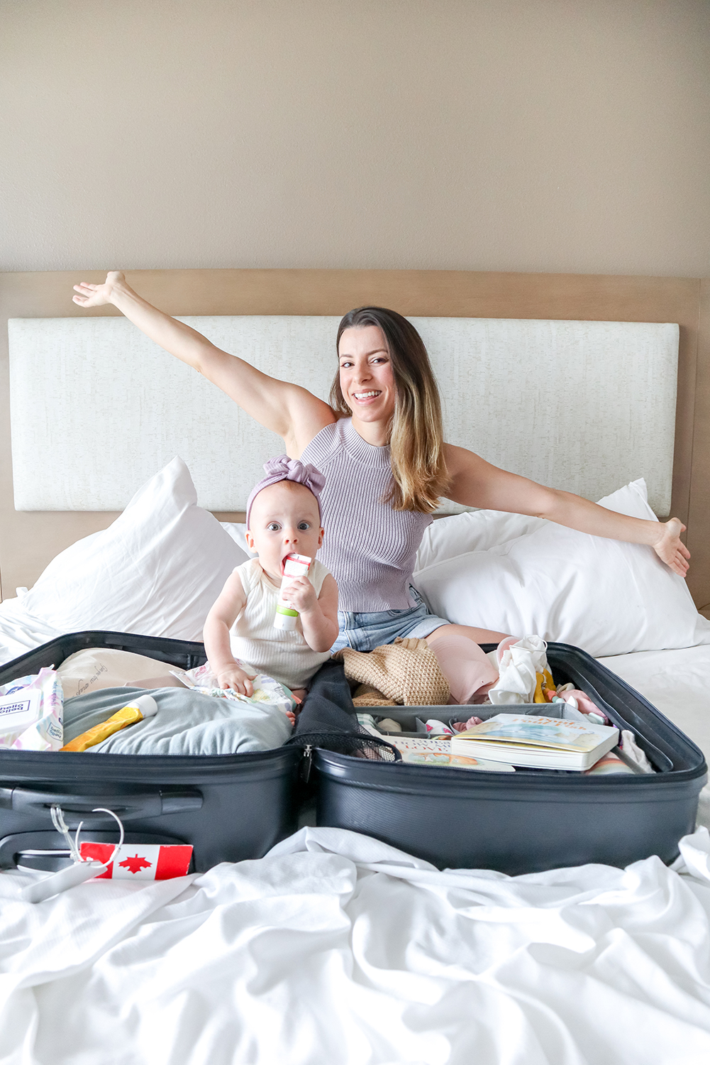 woman and her baby sat in a suitcase