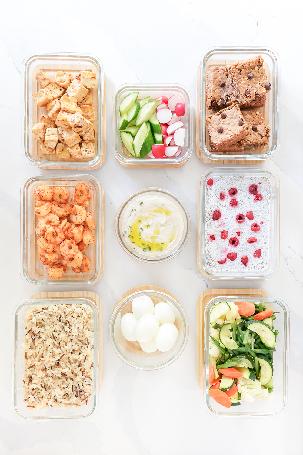 glass containers with a variety of meal prepped food inside them