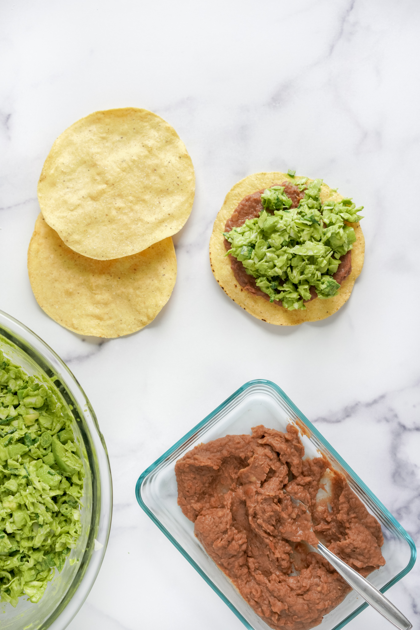 green goddess salad on tostadas with refried beans