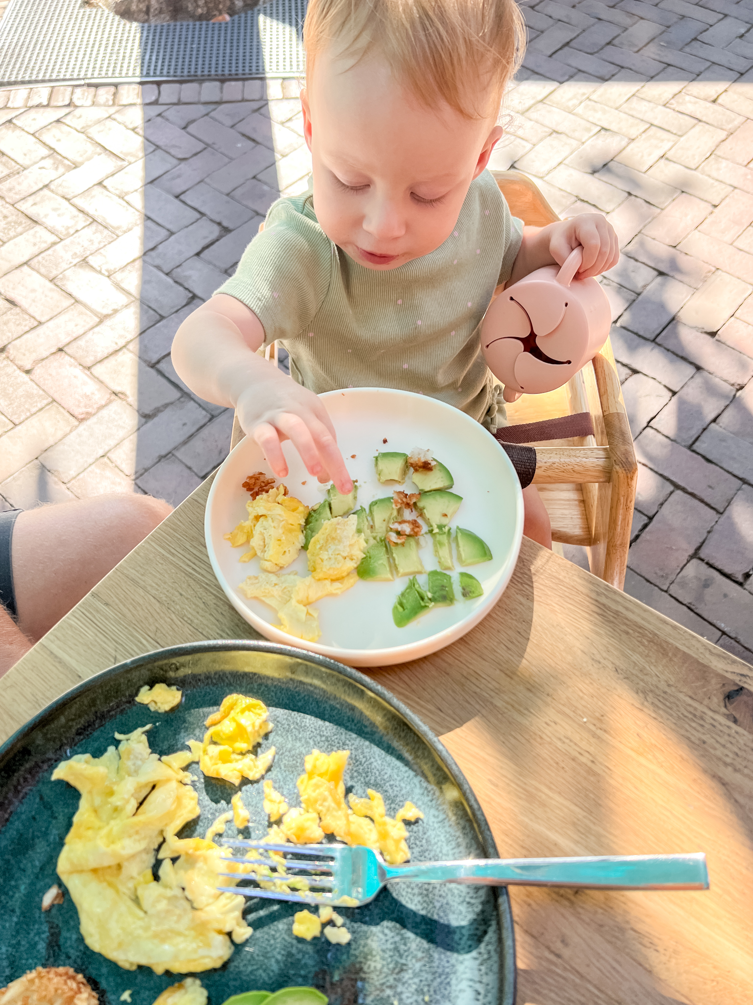 baby eating eggs and avocado