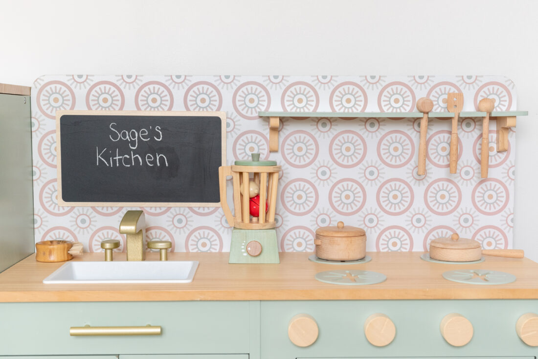 An image of a toy teal kitchen 